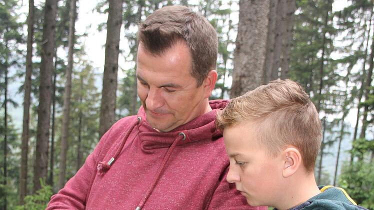 Thorsten Hugel und sein Sohn Leon &uuml;berwachen die Bienenv&ouml;lker per Handy: Die V&ouml;lker sind mit einer Bienenstockwaage und einem Alarmierungssystem ausgestattet. Foto: Sonny Adam