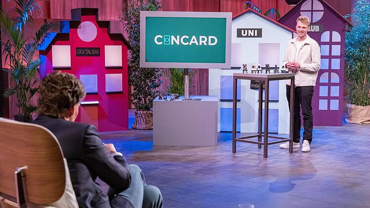 Eine Schutzh&uuml;lle f&uuml;r Kondome im Portemonnaie: Gr&uuml;nder Patrick Beyer (rechts) stellt den verbl&uuml;fften L&ouml;wen seine Start-up-Idee vor.