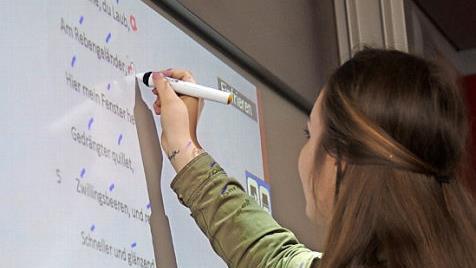 Eine Schülerin des Kronacher Kaspar-Zeuß-Gymnasiums beim Arbeiten an einem Whiteboard. Foto: Marco Meißner