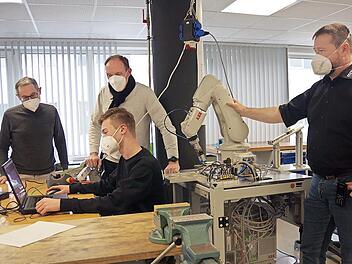 Im Auszubildenden-Zentrum der Firma M.A.i. in Neuses schauen (von links) David Márquez, Werner Zahner und Tobias Geiger dem Azubi Marius (vorne) über die Schulter.