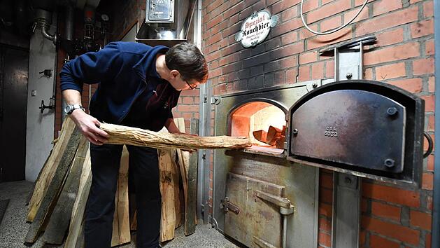 Christian Merz, Inhaber der Bamberger Brauerei Spezial, kontrolliert das Feuer, über dem das Grünmalz gedarrt, also getrocknet wird. Für diese traditionelle Art des Herstellens wurden die Rauchbiere von Spezial und Brauerei Heller in die "Arche des Geschmacks" aufgenommen. Foto: Ronald Rinklef