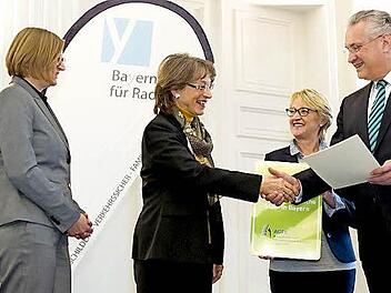 Herzogenaurachs Zweite Bürgermeisterin Renate Schroff erhält bei der zentralen Jahresabschlussveranstaltung aus den Händen von Verkehrsminister Joachim Herrmann die Auszeichnung "Fahrradfreundliche Kommune".  Foto: Tobias Hase/AGFK Bayern