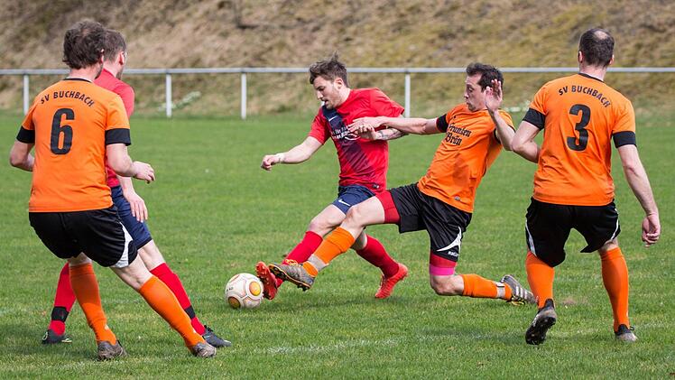 SV Buchbach - TSV Neukenroth II: Vor der Strafraumgrenze geht der Buchbacher Marco L&ouml;ffler mit einer Gr&auml;tsche gegen G&auml;stespieler Felix Appelius (rotes Trikot) zum Ball.  Foto: Heinrich Wei&szlig;