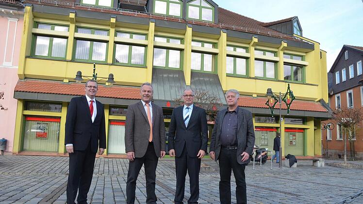 Wolfgang Lohmann, OB Frank Rebhan, Roland Vogel und Richard Peschel stehen vor der heutigen Filiale, die abgerissen wird. (Foto: Rainer Lutz)