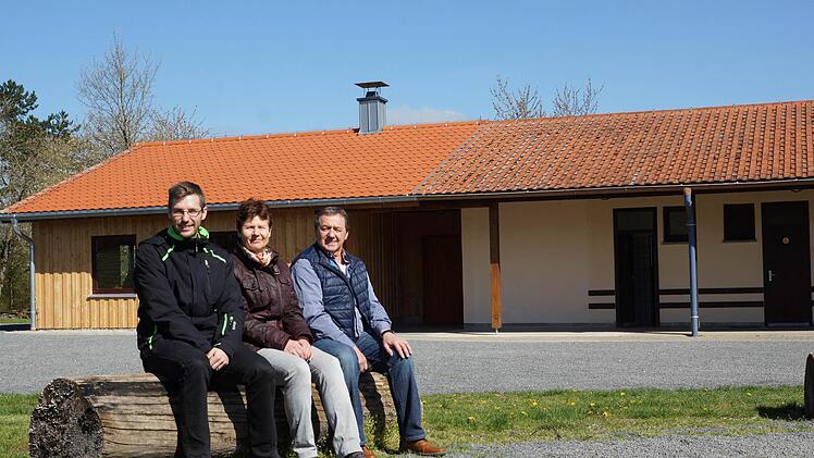 Sie kümmern sich um die Jugendzeltplätze des Landkreises: Kreisjugendpfleger Daniel Korn, Sachbearbeiterin Monika Kiesel und der Hammelburger Platzwart Günter Gaul. Im Hintergrund ist das Gebäude mit dem Anbau (linker Teil) zu sehen. Foto: Arkadius Guzy