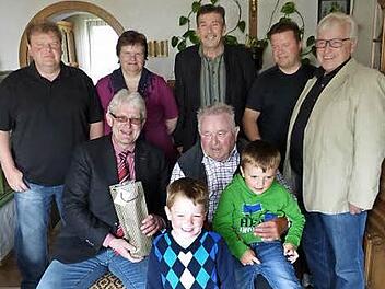 Robert Schott (sitzend, rechts) mit Zweitem Bürgermeister Reiner Meisel, davor die beiden Enkel sowie (hinten, stehend von links) Sohn Michael, Tochter Renate, Schwiegersohn Günter Stöcker, Sohn Wolfgang und Josef Weiß Foto: Klaus-Peter Wulf