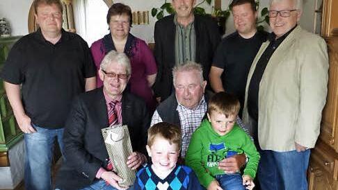 Robert Schott (sitzend, rechts) mit Zweitem Bürgermeister Reiner Meisel, davor die beiden Enkel sowie (hinten, stehend von links) Sohn Michael, Tochter Renate, Schwiegersohn Günter Stöcker, Sohn Wolfgang und Josef Weiß Foto: Klaus-Peter Wulf