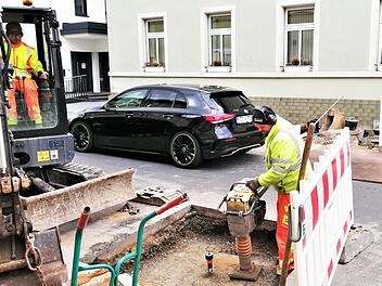 Bauarbeiter schließen wieder das erste der beiden Kopflöcher in der Theresienstraße vor der Villa Nordland.