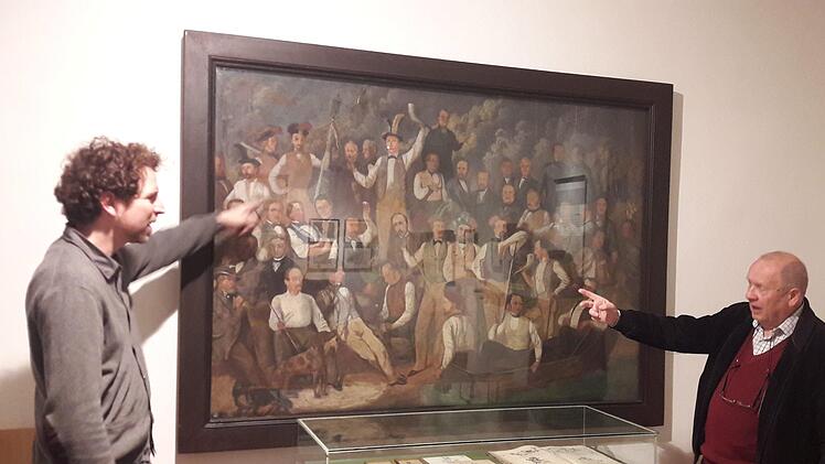 Museumsleiter  Nicolas Zenzen und Stadtarchivar  Klaus-Dieter Guhling suchen und finden das Gesicht von Ignaz Bals im "Reichstruppenbild", das derzeit Bestandteil der Ausstellung "Bals + Bals  , Vater und Tochter" im Hennebergmuseum ist. Noch bis um 6. Januar  können die Arbeiten besichtigt werden.Hartmut Hessel