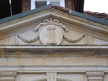 Ornament über dem Portal des alten Rathauses. Der Turm findet sich auch im Wappen der Marktgemeinde wieder und erinnert an die Ursprünge der heute gewaltigen Schlossanlage.Foto: Katrin Geyer