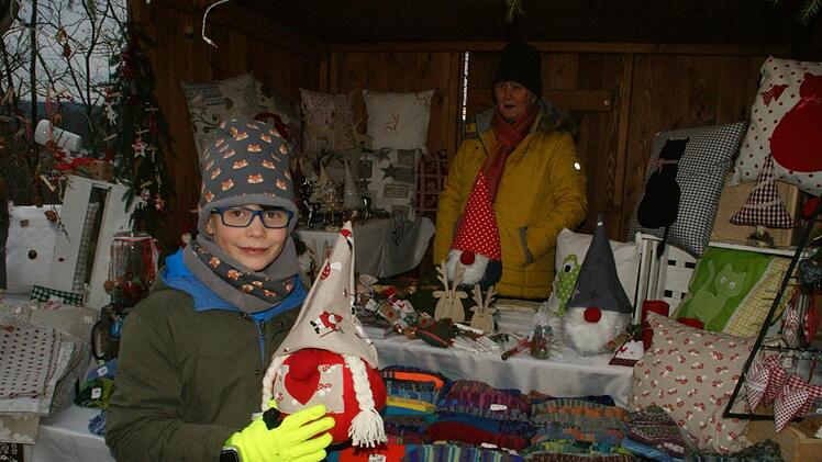 Lenny Engel hat das Talent von Oma Lissi (im Hintergrund) geerbt. Seit seinem Nähkurs hat er Weihnachtswichtel hergestellt, die die Oma ganz stolz in ihrem Stand verkaufte.Sabine Weinbeer