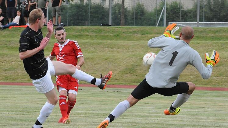 Klare Sache: Reiterswiesens Tobias Ehrenberg trifft gegen Hausens Keeper Sebastian Fichtl zum 3:0. Links: Christoph Schmück. Foto: Hopf