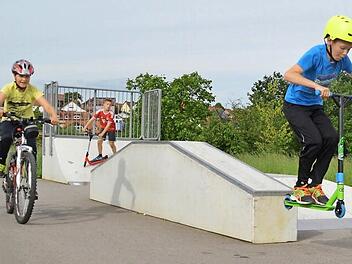 Der "Multi" in Wollbach ist auch mit Skater-Elementen ausgestattet. Marcel (von rechts) und Ramon befahren diese gerne mit ihren Rollern, während Luis auf dem Fahrrad zuschaut. Foto: Kathrin Kupka-Hahn