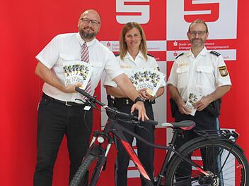 Bei der Verkehrsaktion verlost die Stadt- und Kreissparkasse Erlangen H&ouml;chstadt Herzogenaurach mit Filialleiter Axel Geier (links) in Kooperation mit der Polizei, vertreten durch Michaela Rosenthal und Thomas Gamm, am kommenden Mittwoch  ein Fahrrad. Foto: Mirjam Stumpf