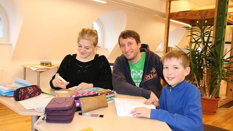 Schulleiter Bernhard Löser (Mitte) geht mit den Schülern Lara Hofmann aus Bad Kissingen und Lorenz Ammersbach aus Garitz den aktuellen Lernstoff und die Eintragungen ins Lerntagebuch. Foto: Ralf Ruppert