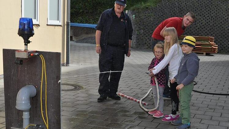 "Zielspritzen" übten diese jungen Besucher; links Kommandant Uwe Kern. Foto: Simon Albrecht