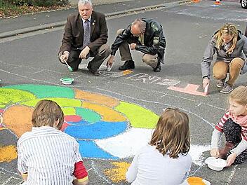 Eine Schnecke pinselten zusammen mit den Kinder Bürgermeister Hennemann, Tobias Kern von der Polizei und Ute Barthelmann, zuständig für Verkehrsrecht im VG-Bauamt (im Bild oben von links), auf die Fahrbahn.  Foto: Ralf Kestel