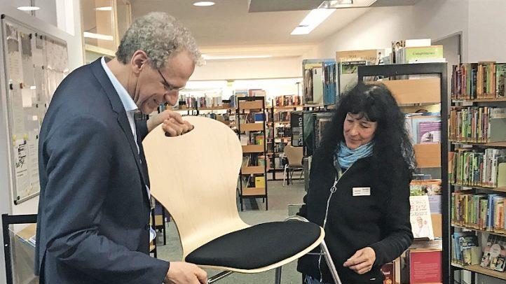 Vor dem Probesitzen wird der Stuhl durch Bibliothekarsleiterin Gabriele Lechner und Bürgermeister German Hacker genau inspiziert.  Foto: Michael Busch