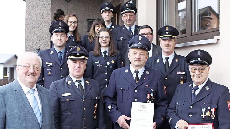 Joachim Hertel (vorne, rechts) wurde zum Ehrengruppenführer ernannt. Georg Barnickel (daneben) wurde für 40 Jahre aktiven Dienst mit dem staatlichen Ehrenzeichen in Gold ausgezeichnet. Mit auf dem Bild sind (vorne, von links) der weitere Stellvertreter des Landrats Bernd Steger, Kreisbrandrat Joachim Ranzenberger sowie Führungskräfte und die weiteren Geehrten. Foto: Michael Wunder