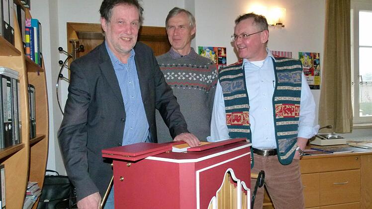 Emil Hartmann (links), Gesamtleiter des Don Bosco Jugendwerks Bamberg, erprobt mit den Salesianern Josef Hauser und Dieter Putzer (rechts) den Leierkasten aus dem Zirkus Giovanni. Foto: Marion Krüger-Hundrup