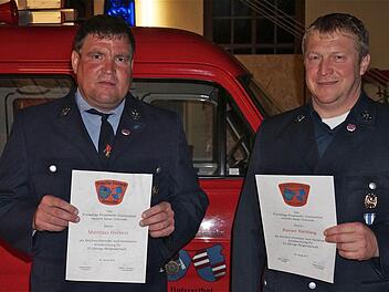Auszeichnung treuer Mitglieder: Mit Silber wurden Matthias Herbert (links)und Reiner Niebling für 25-jährige Mitgliedschaft im Feuerwehrverein geehrt. Im Hintergrund steht das 32 Jahre alte Einsatzfahrzeug, für das die Wehr gern einen Ersatz hätte. Foto: Gerd Schaar