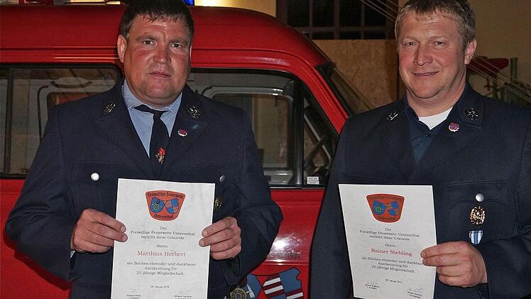 Auszeichnung treuer Mitglieder: Mit Silber wurden Matthias Herbert (links)und Reiner Niebling für 25-jährige Mitgliedschaft im Feuerwehrverein geehrt. Im Hintergrund steht das 32 Jahre alte Einsatzfahrzeug, für das die Wehr gern einen Ersatz hätte. Foto: Gerd Schaar