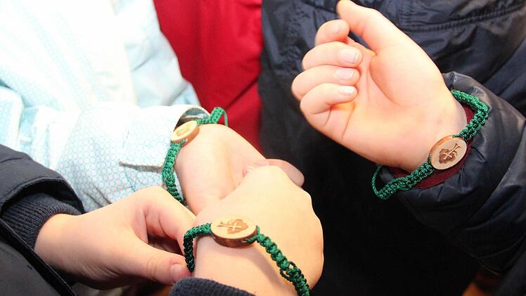 Stolz zeigen die Kinder ihre Freunschaftsbändchen