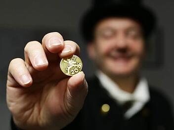 Dieter Spaderna zeigt einen kleinen Glücksbringer in Form einer Münze für 2016, die er an Kunden verschenkt.  Foto: Hendrik Steffens