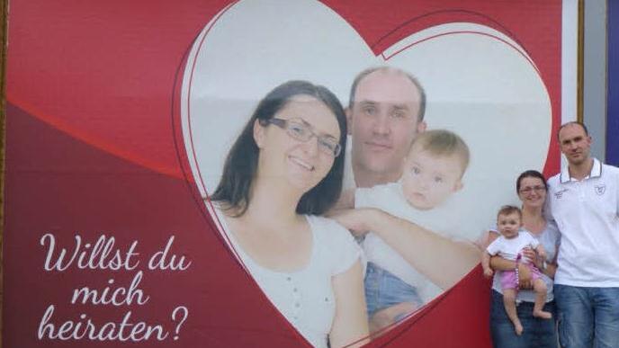 Erinnerungsfoto für das künftige Familienalbum: Stephan steht mit Freundin Stefanie und dem gemeinsamen Töchterchen vor seinem plakativen Heiratsantrag in der Herzog-Max-Straße.  Foto: privat