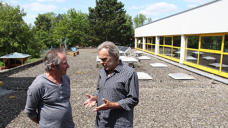 Schulleiter Ludwig Klaus (r.) und Hausmeister Dieter Exner stehen  auf dem sanierungsreifen Dach des Altbaus der Don-Bosco-Schule. Foto: Christian Bauriedel