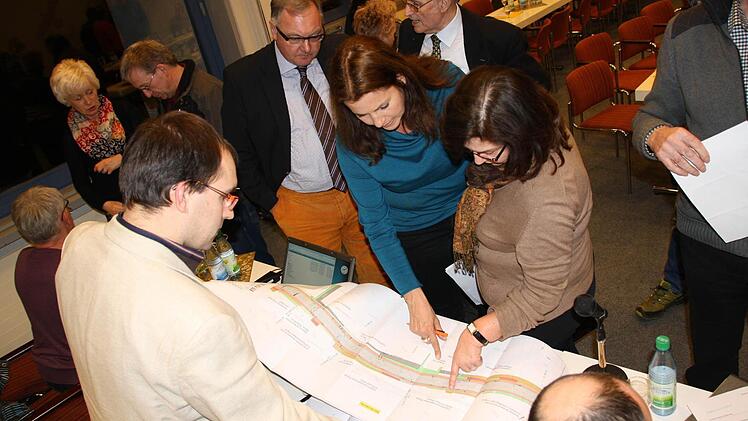 Jede Menge Fragen klärten Bauingenieur Gerhard Schwarzer (links vorne) und die weiteren Planer im Rahmen der Anliegerversammlung gleich anhand der Pläne. Fotos: Ralf Ruppert