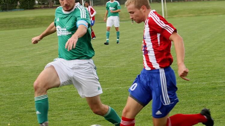 Der Dampfacher Philipp Geßendörfer (rechts) flankt gefährlich vors Tor, Gästekapitän Benedikt Carton kommt zu spät.Foto: Günther Geiling