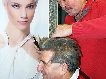 Friseurmeister Ingo Mayer kümmert sich um einen Kunden. Foto: Andreas Welz