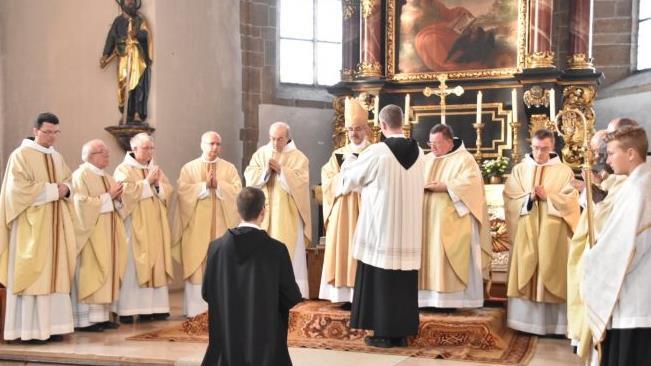 Frater Patrick kniet vor dem Abt und den Priestern. Er hat sich entschieden, Mönch "auf Zeit" zu werden.  Foto: privat