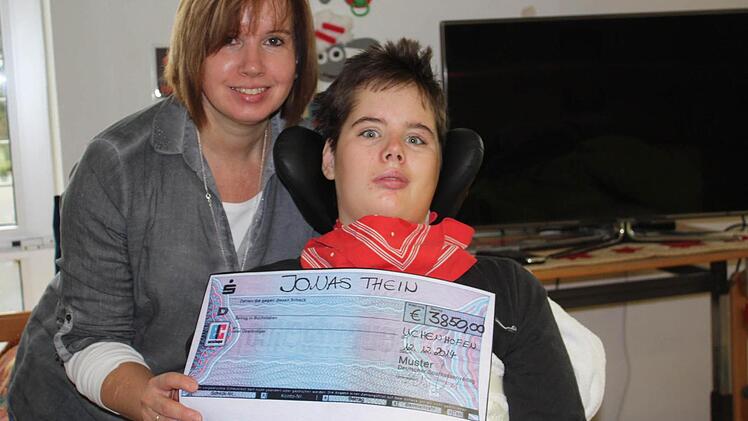 Heike Thein freut sich über die Spende der Dorfbewohner. Das Geld ermöglicht es ihr, ihren Sohn Jonas bei dessen Reha-Maßnahme zu begleiten. Foto: Manfred Wagner