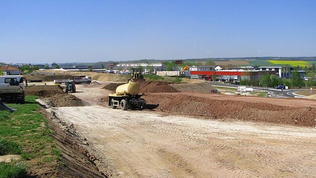 Aufsch&uuml;ttung des restlichen L&auml;rmschutzdamms (insgesamt 430 Meter); dahinter m&uuml;ndet die Ortsverbindungsstra&szlig;e Meschenbach - Untersiemau in den Kreisverkehr (rechts unten).  Foto: Norbert Karbach