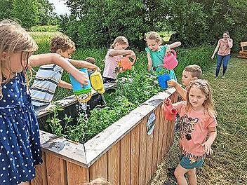 Auch die neu angelegten Hochbeete werden von den Kindern gegossen.