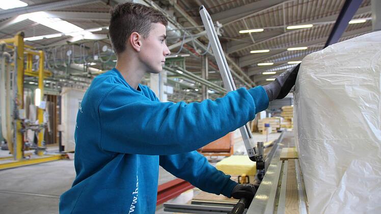 Arbeit für ein Dachelement: Nach dem Ausmessen sägt Zimmerer-Azubi Tobias Frischat die Dämmwolle zurecht... Foto: Benedikt Borst