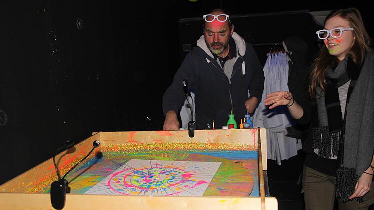 Hier entsteht unter Schwarzlicht auf einer Drehscheibe ein Kunstwerk aus Neonfarben.  Foto: Diana Fuchs