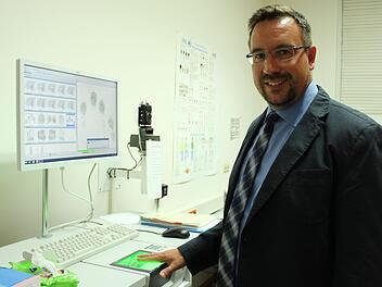 Fürs Foto demonstriert der neue Kripo-Chef Rainer Schmeußer, wie der moderne Fingerabdruck-Scanner in der Coburger Dienststelle arbeitet. Foto: Ulrike Nauer