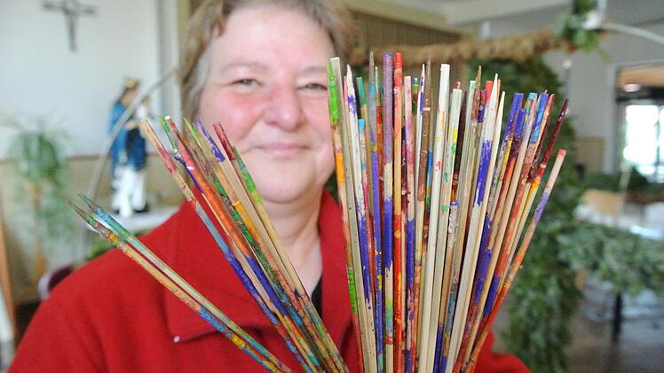 Lisa Moser zeigt die Stäbchen, auf die die Ostereier (aus Plastik) aufgespießt werden, um sie bemalen zu können. Jahr für Jahr stecken die Frauen der Ebelsbacher KAB viel Zeit und Liebe in die Gestaltung des Osterbrunnens in der Stettfelder Straße.Brigitte Krause