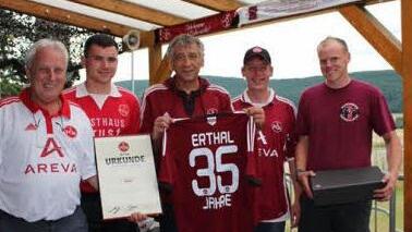 Jürgen Bergmann (Bildmitte), der Fanclub-Beauftragte des FCN, überreichte eine Urkunde und ein Trikot des "Clubs" zum 35-jährige Bestehen des Fanclubs "Erthal".