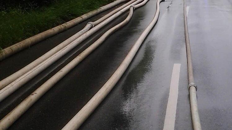 Mit einer langen Schlauchstrecke musste die Feuerwehr in Neunkirchen am Brand anrücken, um zu verhindern, dass Keller voller Wasser laufen. Foto: Frank Hofmann