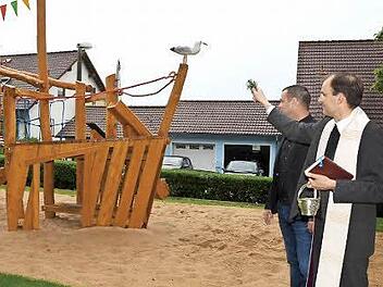 Gottes Segen für den neugestalteten Spielplatz erbat Kaplan Paul Reder. Dahinter Bürgermeister Toni Schick. Foto: Peter Rauch