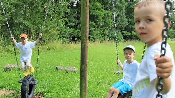 Tayler, Yannick und Alex testen die neue Reifenschaukel. Das Ger&auml;t wurde vom Ma&szlig;bacher Bauhof wieder hergerichtet. Foto: Heike Beudert