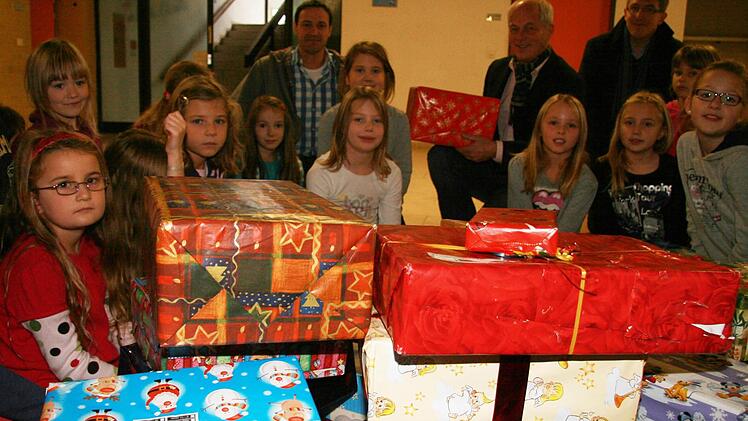 Einen Berg  an Geschenken haben die Stadtsteinacher Grundschüler  für arme Kinder in Rumänien, Moldawien und der Ukraine aufgetürmt. Schulleiter Michael Pfitzner, Berndt Lengenfelder von Round Table sowie Pfarrer Ulrich Böhm aus Neuenmarkt sind begeistert. Foto: Sonja Adam