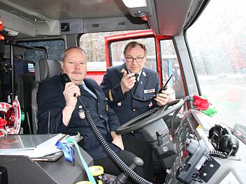 Kreisbrandinspektor Thomas Eyrich (von links) und Kreisbrandrat Benno Metz zeigen je eines der neuen digitalen Fahrzeug- und Handfunkgeräte. Seit 2. Januar sind sie offiziell in Betrieb. Foto: Ralf Ruppert