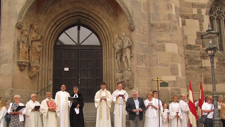 Bis zur Reformation war die St.-Moriz-Kirche Start und Ziel der  Fronleichnamsprozession in Coburg. Heute ist sie die Station, an der das  Evangelium verkündet wird. Der Klerus von links: Pastoralreferentin  Birgit Müller, Pastoralreferent Ralph Walta, Dekan Roland Huth,  Pfarrerin Martina Schwarz-Wohlleben, Pfarrer Tomasz Dzikowski und Kaplan  Florian Sassik. Das weltliche Regiment vertraten SPD-Oberbürgermeister  Norbert Tessmer und SPD-Stadträtin Monika Ufken. CSU-Stadtrat Jürgen  Oehm war...