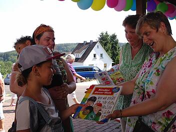 Maria nahm erfreut die Spiele- und Bücherspende von Lisa Kinalele und Margarethe Wollmann vom katholischen Frauenbund an. Foto: Stephanie Elm