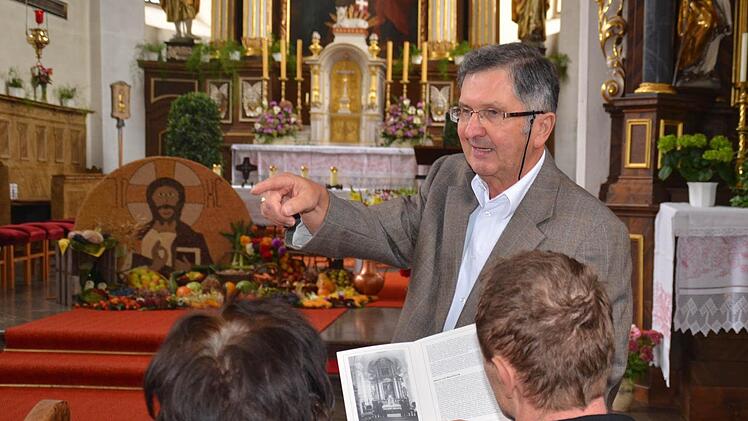 Kirchenpfleger Georg Rottenberger ist bestens mit der Geschichte der Burkardrother Pfarrkirche vertraut. Den Besuchern erklärte er bei einer Kirchenführung am Sonntagnachmittag, wie der Altarraum vor seinem Umbau 1968 aussah. Zudem sprach er von der bevorstehenden Sanierung der Kirche. Foto: Kathrin Kupka-Hahn